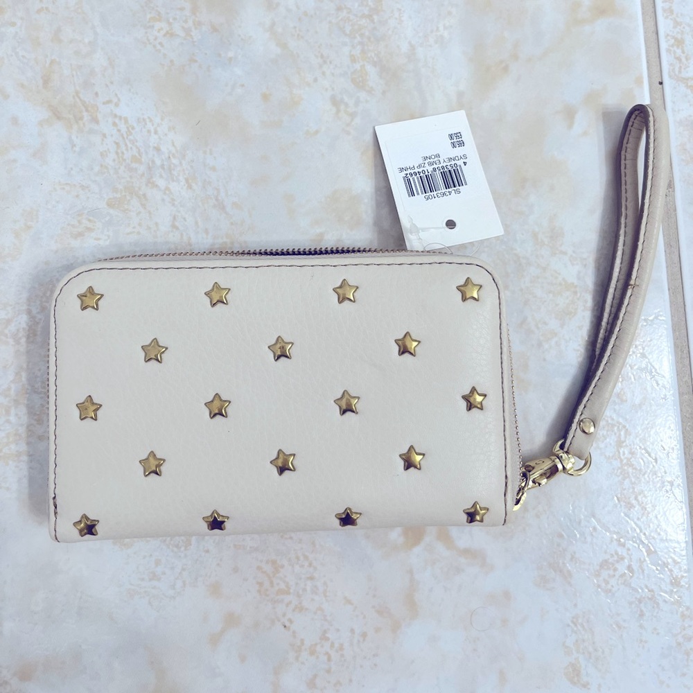 Fossil leather wristlet with star details. Brand new with tags!